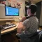 person exploring career paths in livestreaming with laptop camera and microphone